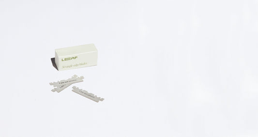A box labelled "LEAF 50 single edge blades" sits on a white counter with 3 loose blades in front of it.