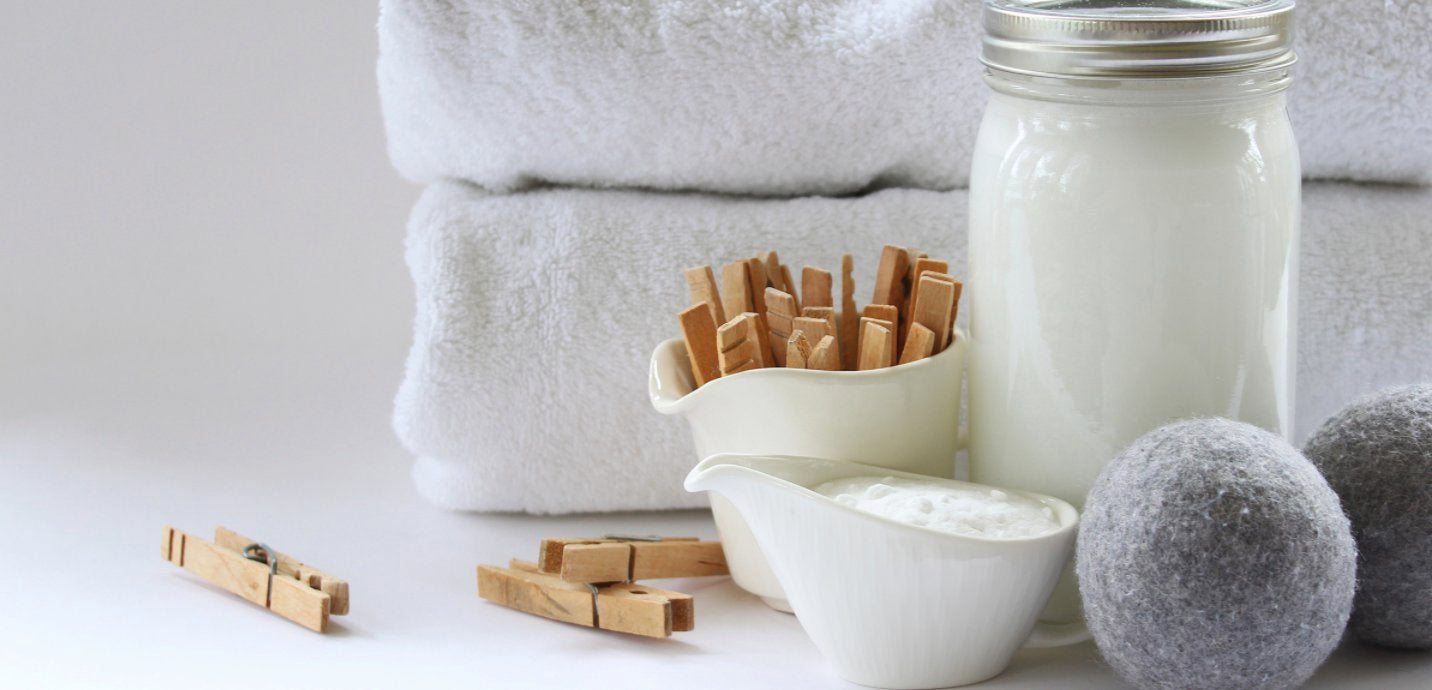 Image of a white sheet on a cloths line being held with a wooden clothes peg.