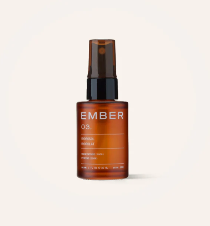 Facial Hydrosol in a glass amber bottle with a spray bottle top.