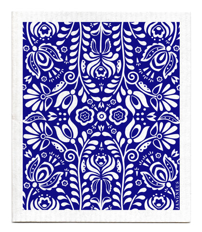 White kaleidoscope pattern of flowers and leaves on a blue background. Kaleidoscope is mirrored 4 ways. 