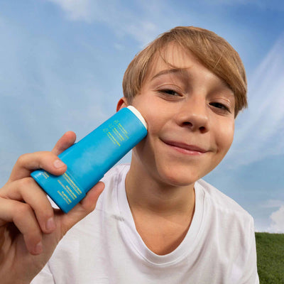 Photograph of child using Kids Mineral Sunscreen Face Stick SPF 30, from ATTITUDE's "Sunly" line.