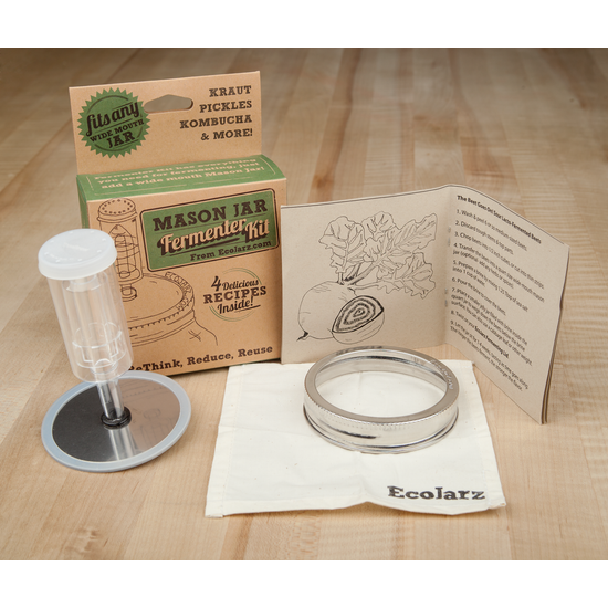 Kraft box of fermenting tools, including a paper booklet, syringe like tool, and mason jar top.