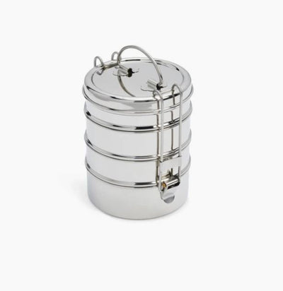 4 tier stackable stainless steel food containers. The top tier is opened. There is are clasps on two sides to hold it together. 