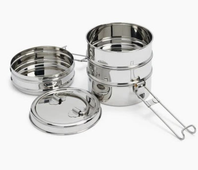 4 tier stackable stainless steel food containers. The top tier is opened. There is are clasps on two sides to hold it together. 