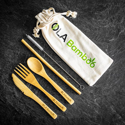 Sustainable, biodegradable bamboo zero waste kit containing 1 bamboo straw with 1 cleaning brush, 1 fork, 1 knife, and 1 Teaspoon made of bamboo along with a travel bag available at Replenish General Store.
